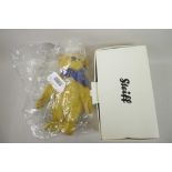 A Steiff 1909 replica teddy bear with growler and blue bow, 13" tall, in original box and packaging