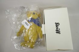 A Steiff 1909 replica teddy bear with growler and blue bow, 13" tall, in original box and packaging