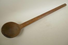 A large African carved hardwood ladle, 32½" long