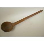 A large African carved hardwood ladle, 32½" long