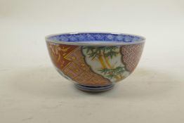 A Japanese Imari porcelain rice bowl with bamboo and cypress tree decoration, six character mark