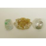 Three Chinese jade and hardstone pendants with carved dragon and phoenix decoration, largest 3" x 2"