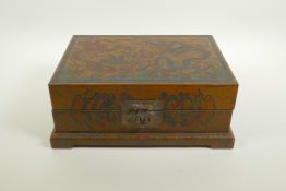 A Chinese lacquer box with engraved and painted decoration of dragons chasing the flaming pearl, 12"
