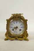 A French brass Rococo carriage clock, the movement striking on a bell, the enamel dial with Roman