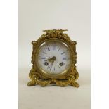 A French brass Rococo carriage clock, the movement striking on a bell, the enamel dial with Roman