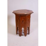 A Moorish style inlaid solid burr yew wood occasional table with folding base and octagonal top, 19"