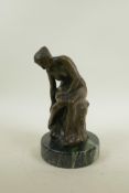 A bronze figure of a female nude, seated, after Luis Noeé, 9" high