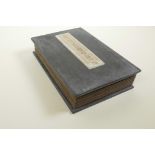 A Chinese hardwood and material bound book containing white jade tablets with chased and gilt