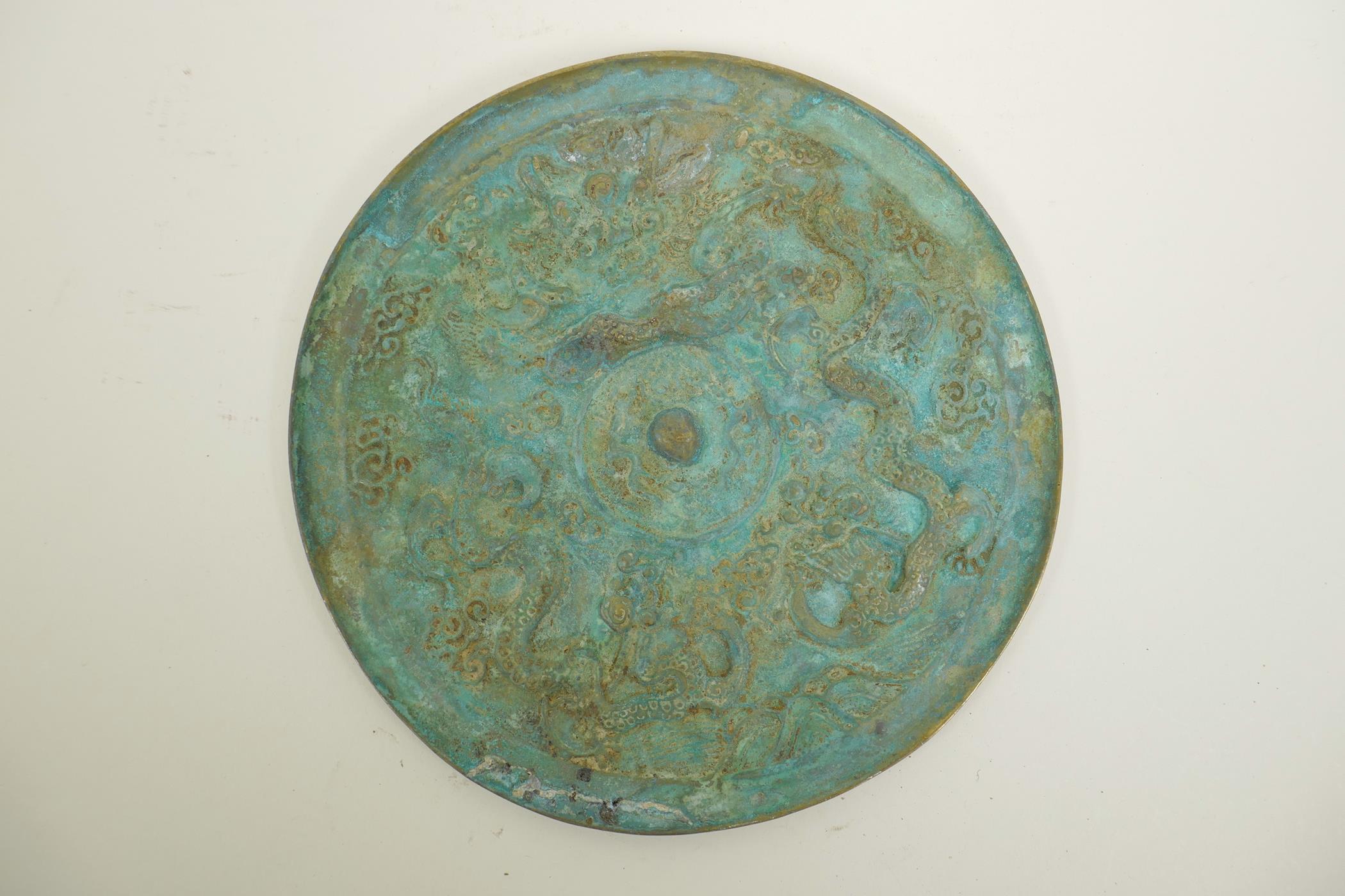 A Chinese bronze circular plaque with raised dragon and character decoration, 9½" diameter - Image 2 of 2