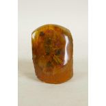 A faux amber paperweight containing insects, 2½" high