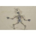A silver articulated skeleton pendant, 2½" long