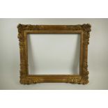 A good early C20th gilt picture frame, having pierced scroll and flower decoration, rebate 19" x