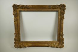 A good early C20th gilt picture frame, having pierced scroll and flower decoration, rebate 19" x