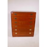 A mid C20th teak chest, comprising six drawers with military style handles, raised on a plinth base,