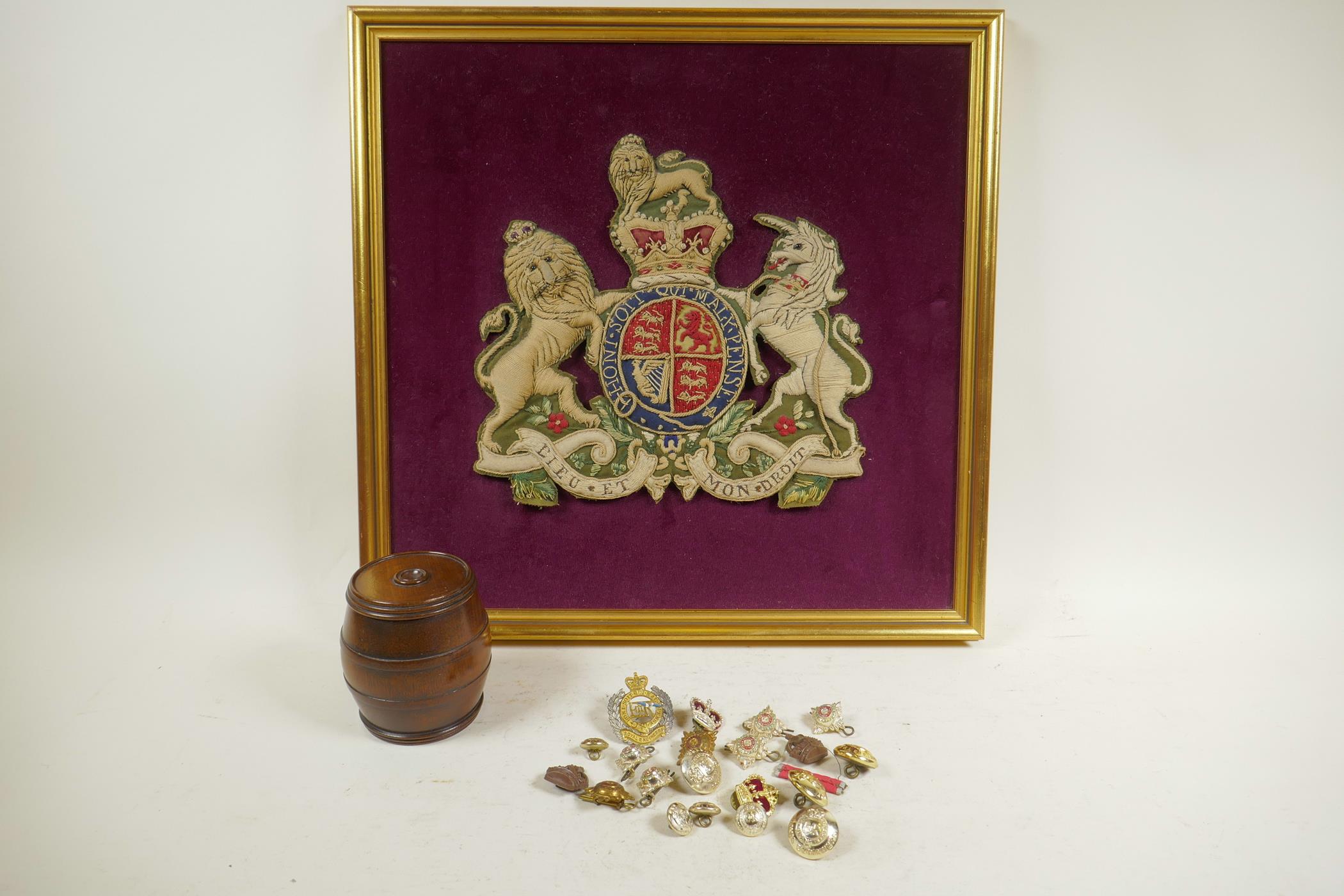 A stumpwork of the royal coat of arms, 15" square, together with a small quantity of military badges