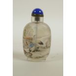 A Chinese reverse decorated glass snuff bottle depicting figures and birds in a landscape, 3½" high