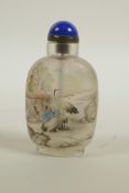 A Chinese reverse decorated glass snuff bottle depicting figures and birds in a landscape, 3½" high