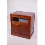 A Chinese hardwood media cabinet, with glazed fall front over two cupboards, 26" x 18" x 28"