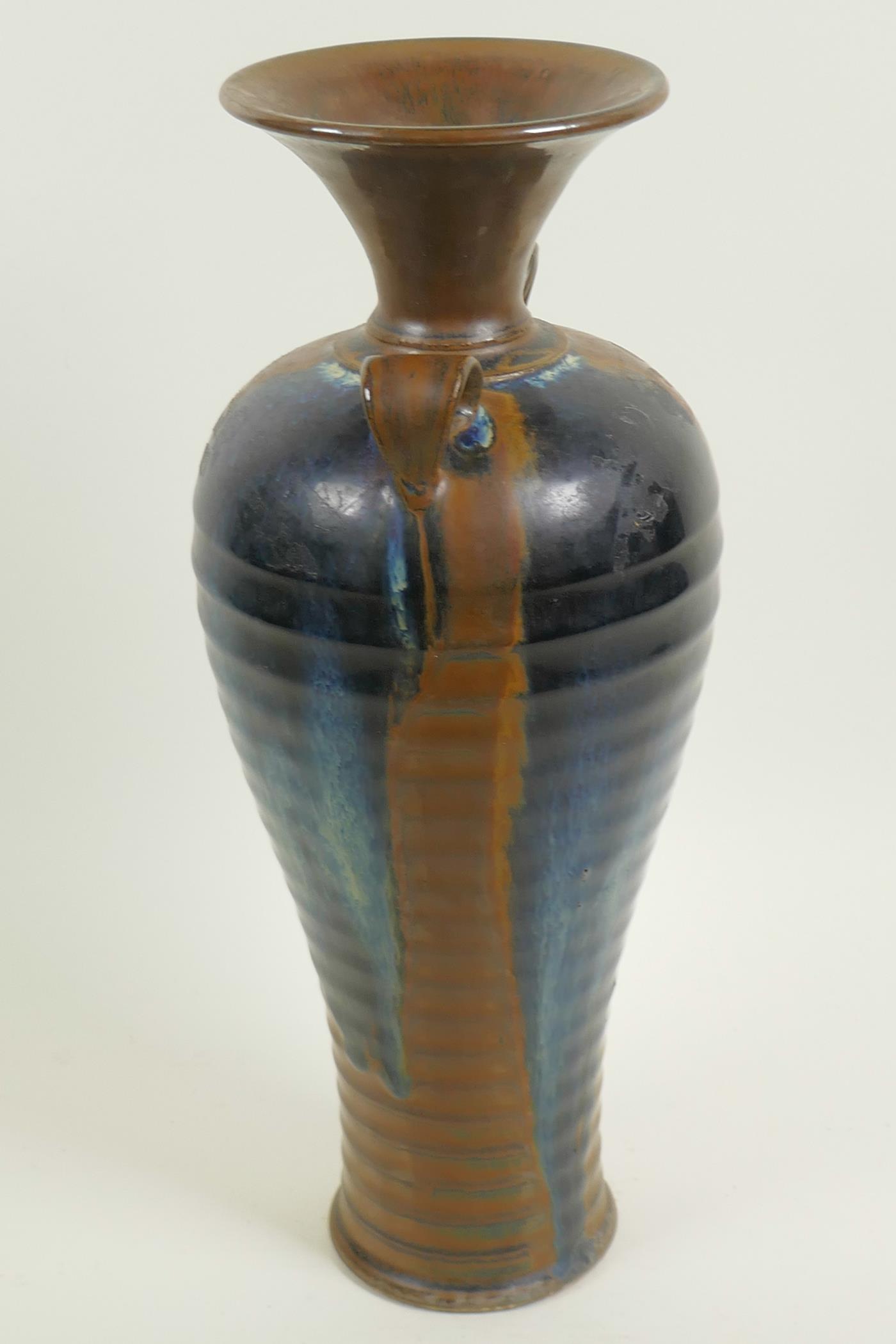 A Chinese stoneware baluster vase with rib formed body and two loop handles, drip glazed in brown - Image 3 of 4