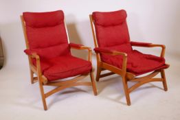 A pair of mid century beechwood open arm easy chairs