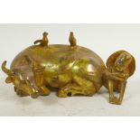 A Chinese gilt bronze figurine of a buffalo and his boy handler, 7" long