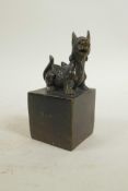 A Chinese filled bronze seal, the surmount in the form of a kylin, 2" x 2", 4½" high