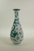 A Chinese late C19th/early C20th slender necked porcelain vase decorated with green enamel dragons