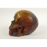 A resin skull moulded with mystic symbols, 5½" high