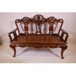 A late C19th/early C20th padauk wood window seat with carved and pierced decoration incorporatinf