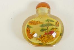 A Chinese interior painted glass snuff bottle decorated with landscape scenes, 2" high