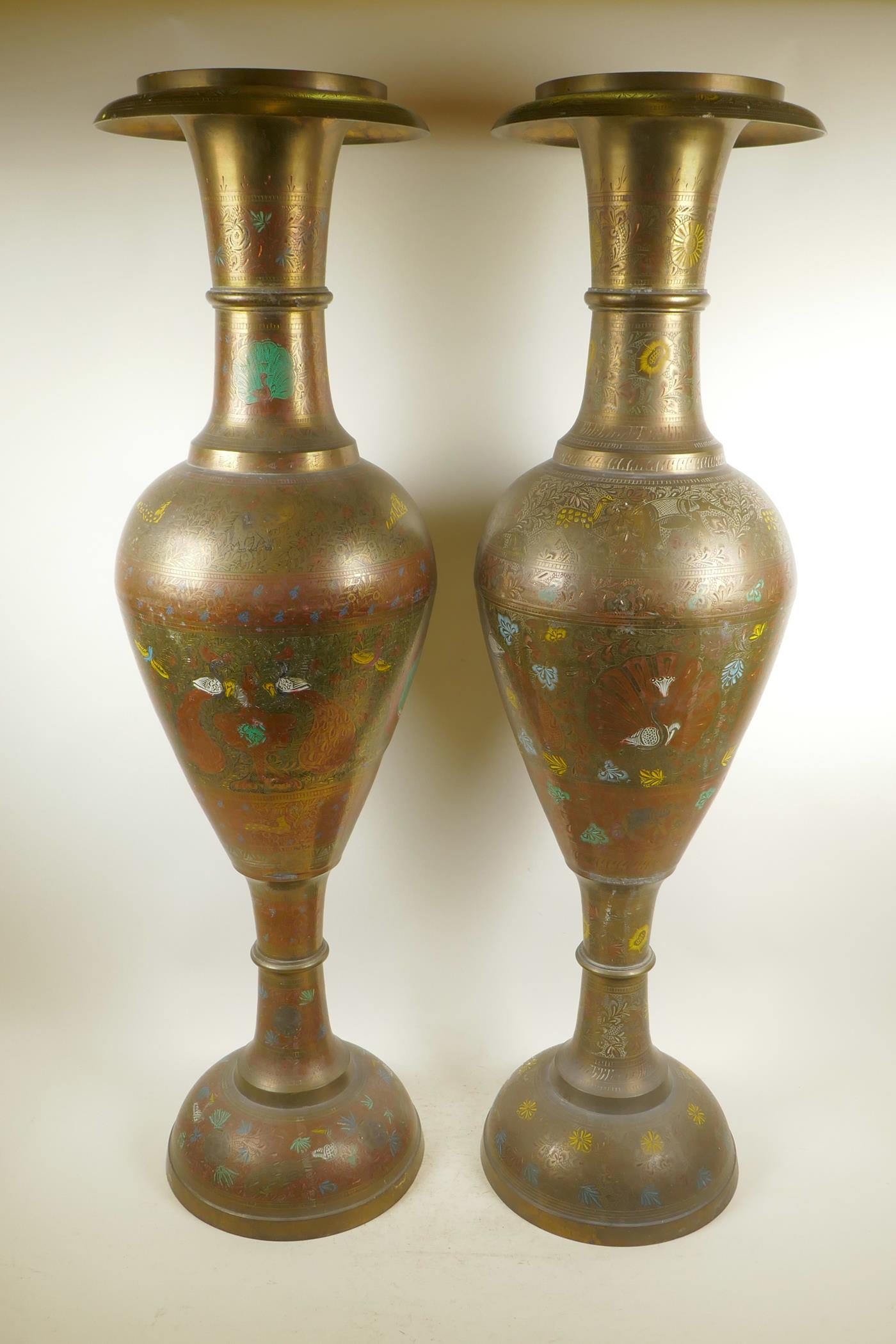 A pair of large Indian brass floor vases with engraved and painted decoration depicting peacocks,