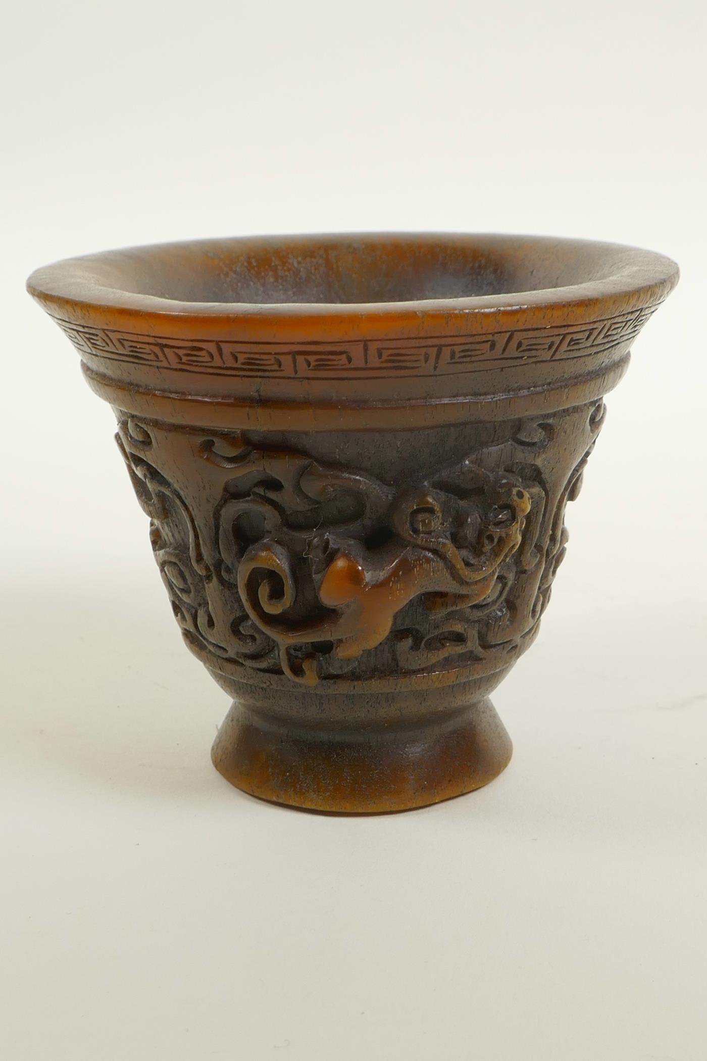 A Chinese faux horn libation cup with two carved handles in the form of a climbing kylin, - Image 3 of 4