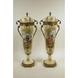 A pair of French cream ground porcelain urns and covers with gilt metal mounts and handles,