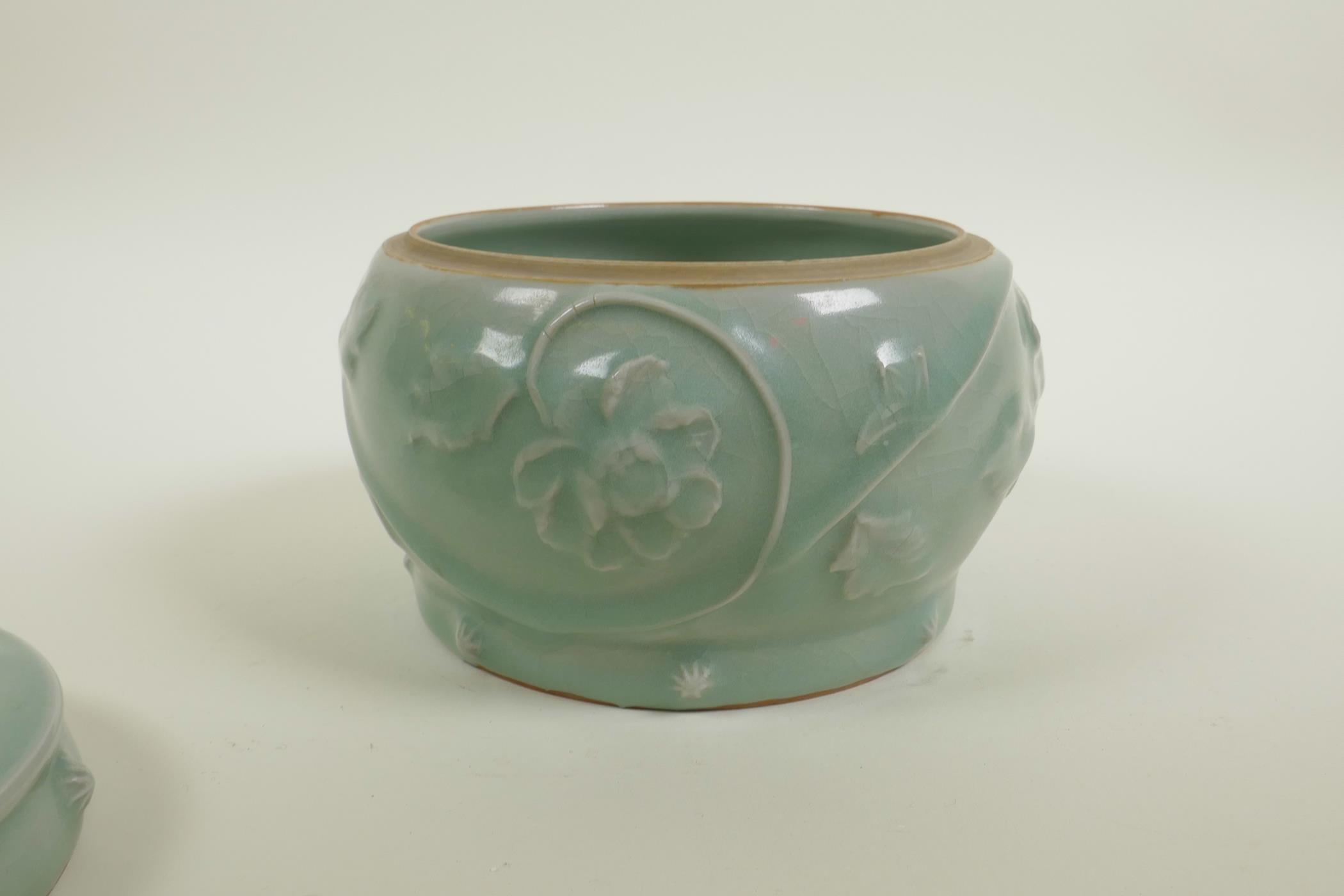 A Chinese celadon crackle glazed porcelain pot and cover with raised underglaze dragon and lotus - Image 4 of 5