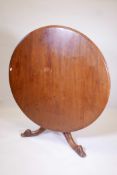 A mid C19th tilt top breakfast table in walnut, with circular top, on a solid turned central support