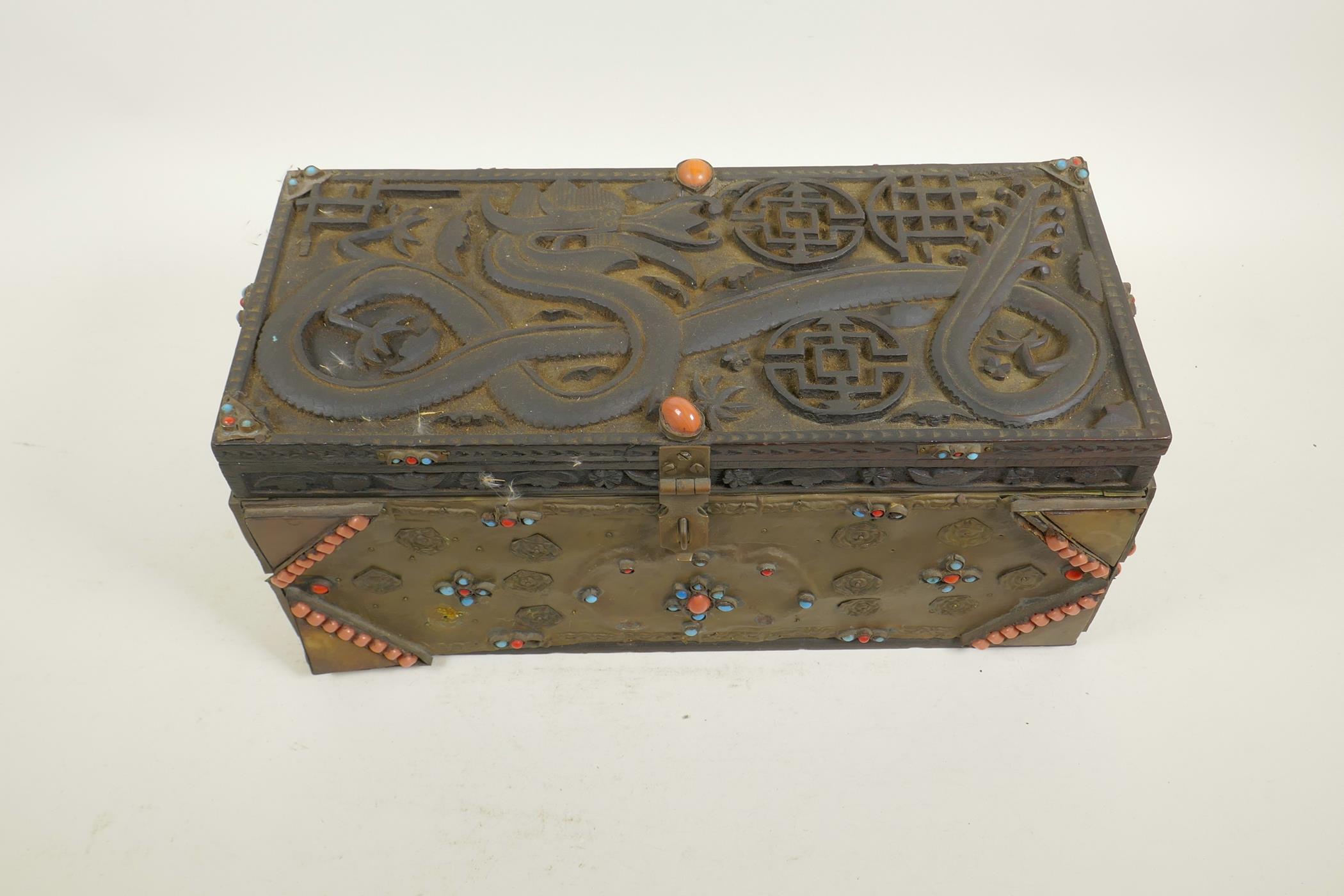 A Sino-Tibetan brass bound carved hardwood casket, with dragon and auspicious symbol decoration, and - Image 2 of 5