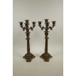 A pair of bronzed spelter three branch candlesticks on Corinthian column and triform bases, 16" high