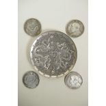 A Chinese white metal coin dish with raised dragon decoration, and four facsimile (replica)