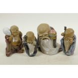 Four Chinese, Shiwan style, mud men shaven head pilgrim figures, 4½" high