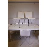 A white lacquered table and six leather chairs raised on chromed supports, table 66" x 32" x 30"