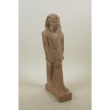 An Egyptian reconstituted stone figure of a pharaoh, 11½" high