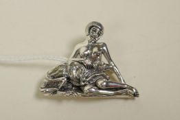 A sterling silver brooch in the form of a female nude and her dog, 1½" wide