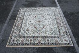 A cream ground square rug with an Oriental multicolour floral design, 77½" x 77"