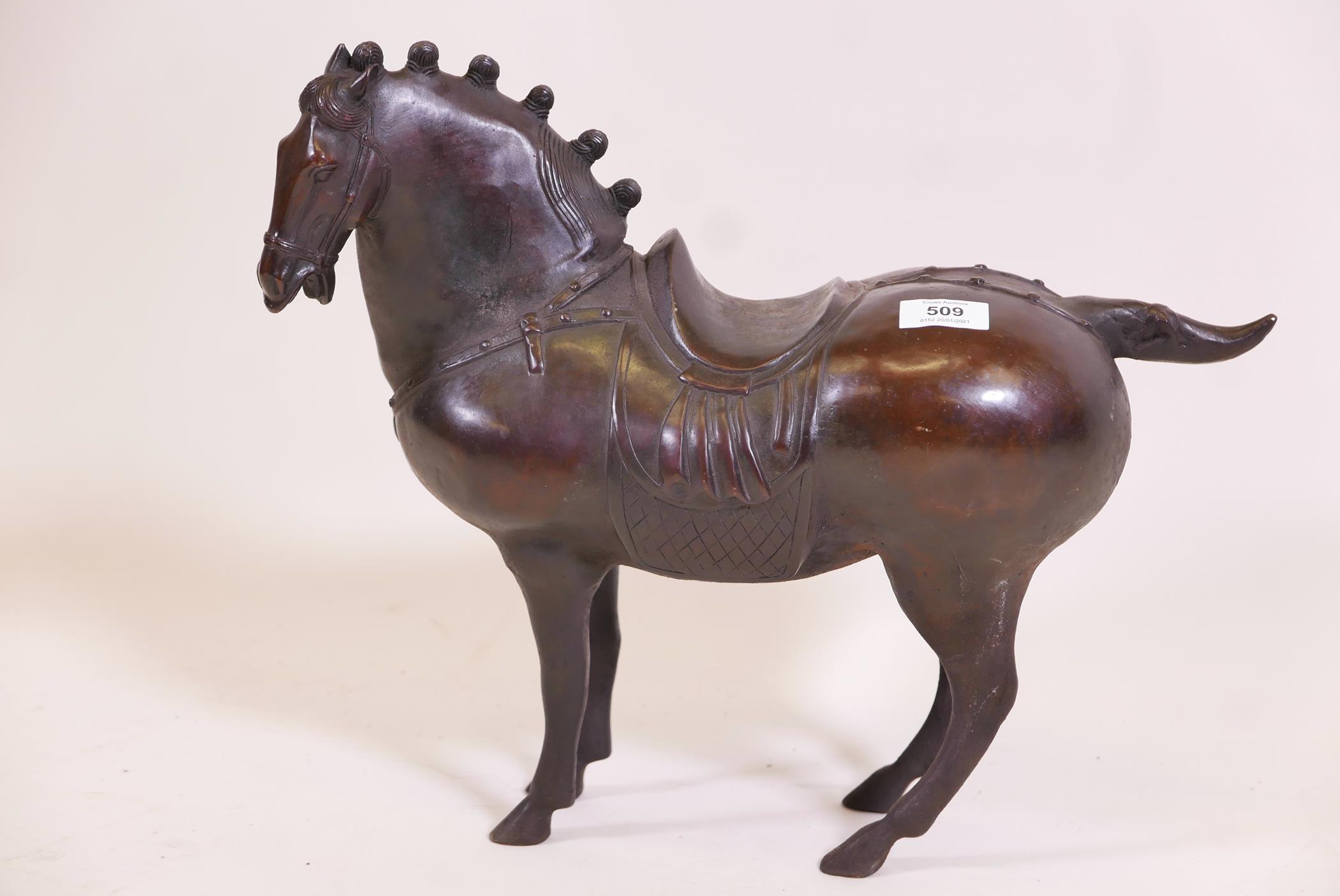 A Chinese bronze figure of a horse with saddle and harness, 15" high