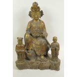 A Chinese gilt bronze figure of a seated deity accompanied by two small acolyte figures, 15" high