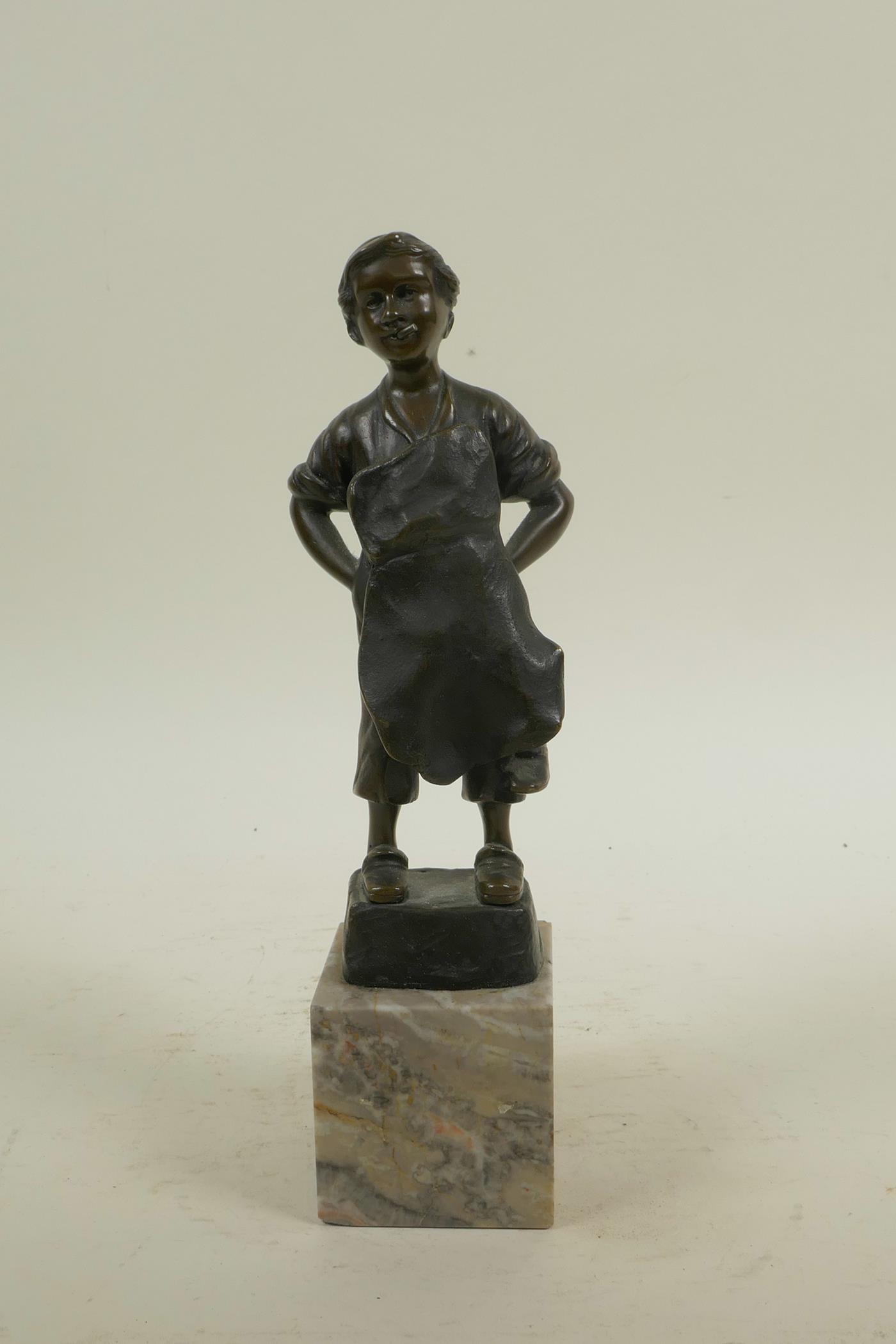 A bronze figure of a child cobbler, 8½" high, indistinctly signed verso