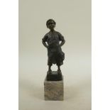 A bronze figure of a child cobbler, 8½" high, indistinctly signed verso