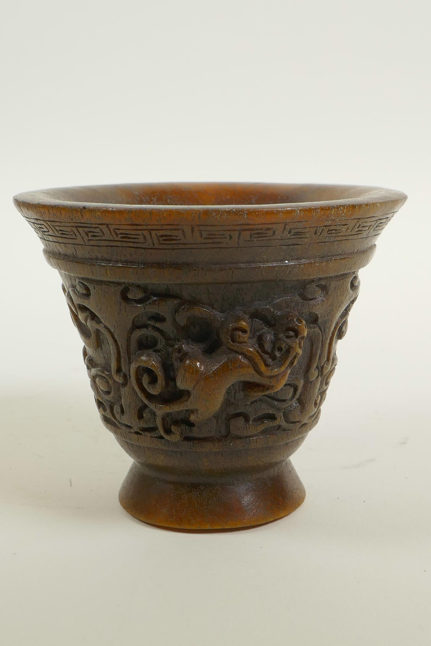 A Chinese faux horn libation cup with two carved handles in the form of a climbing kylin, - Image 2 of 4