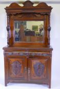 A Victorian walnut mirror backed sideboard with shaped top and bevelled glass over two moulded front