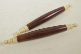 A pair of Oriental hardwood and bone scroll weights, 12" long